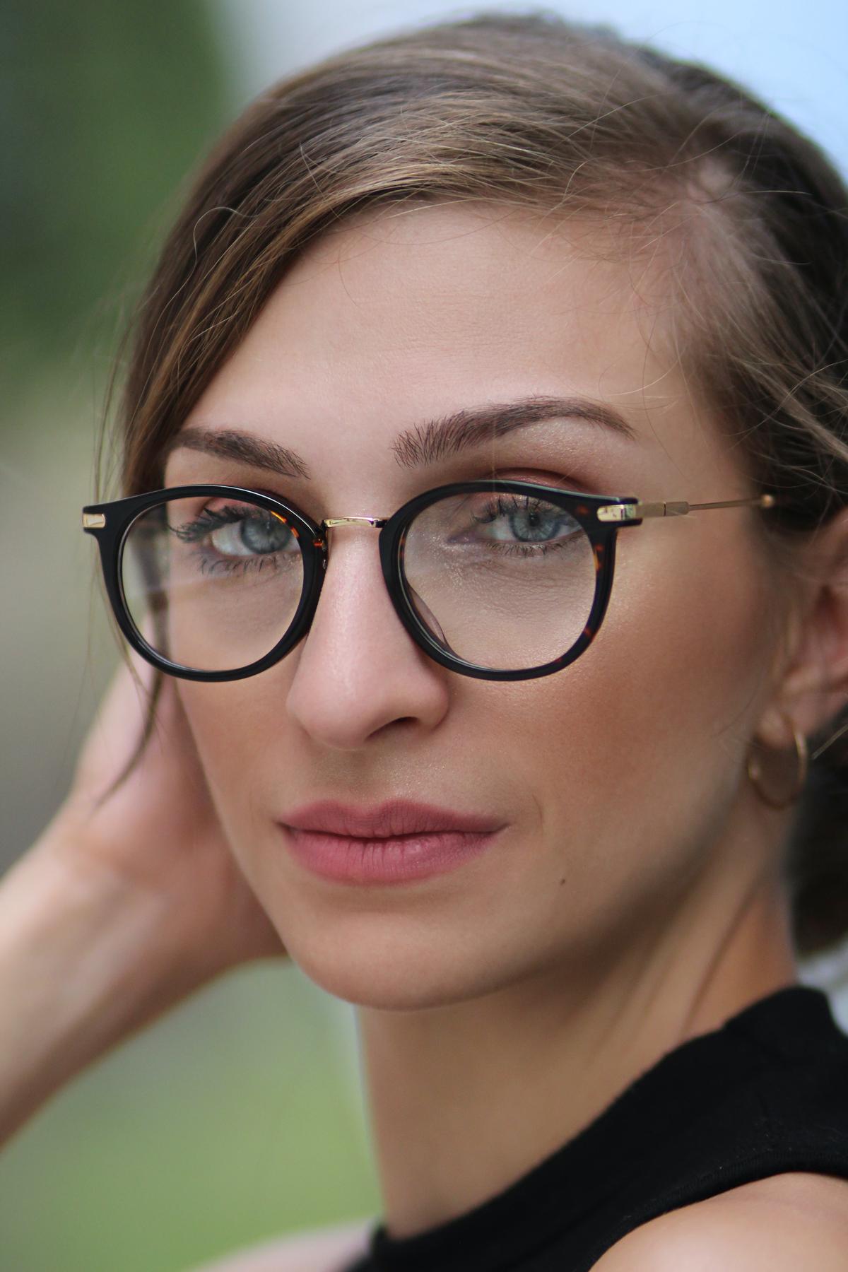 An image depicting a person wearing prescription glasses from Costco Optical.